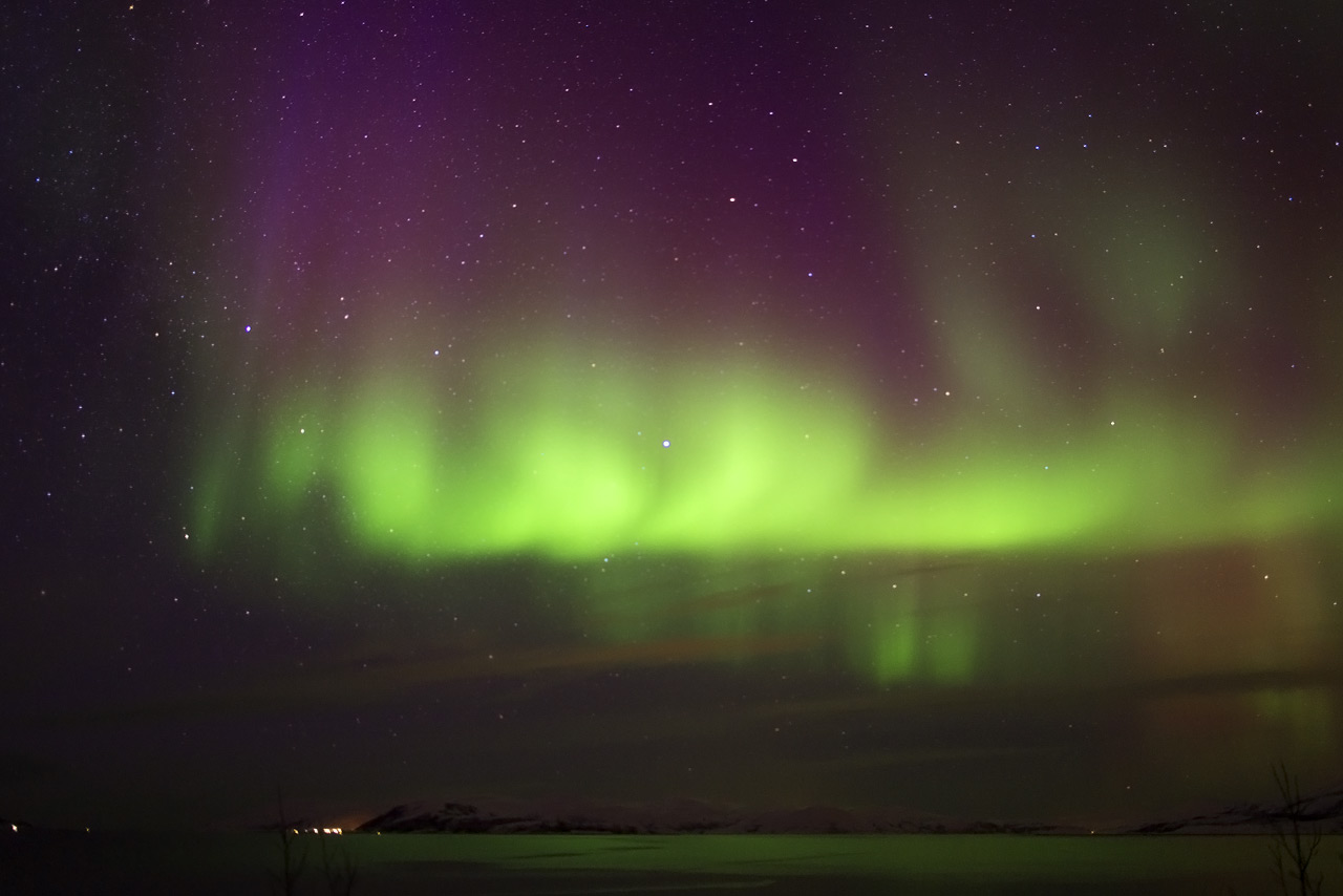 Aurora Borealis dancing over a frozen Arctic lake